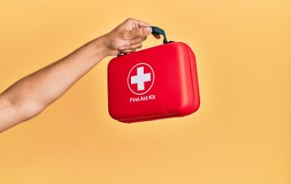 arm stretched out holding a K9 first aid kit