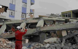 A search and rescue dog climbing through a collapsed building illustrating the process of Uncovering Hidden Evidence & People