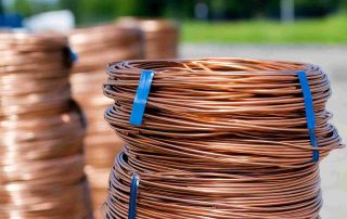 Combating Copper Cable Theft illustrated by coiled copper wire stacks ready for industrial use