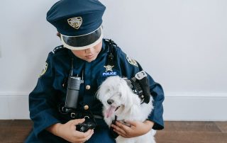canine allies illustrated bya little boy in police uniform with a dog